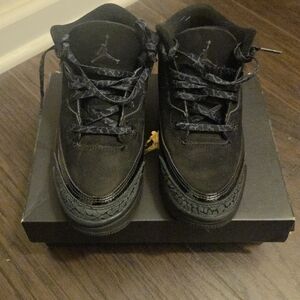 Kid's Air Jordan 3 Retro "Black Cat" sneakers. 